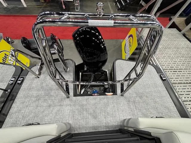 Slide: The Image of 2025 Harris Cruiser 230 boat deck with chrome railing and motor. - 11