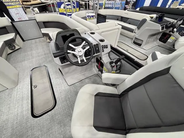 Slide: The Image of Interior of 2025 Harris Cruiser 230 boat with modern seating and steering console. - 18