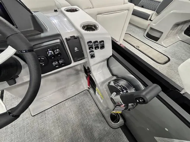 Slide: The Image of 2025 Harris Cruiser 230 boat interior with steering wheel and control panel. - 19