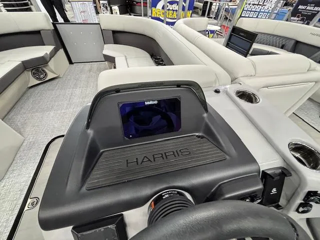 Slide: The Image of 2025 Harris Cruiser 230 boat interior with Simrad display and comfortable seating. - 20