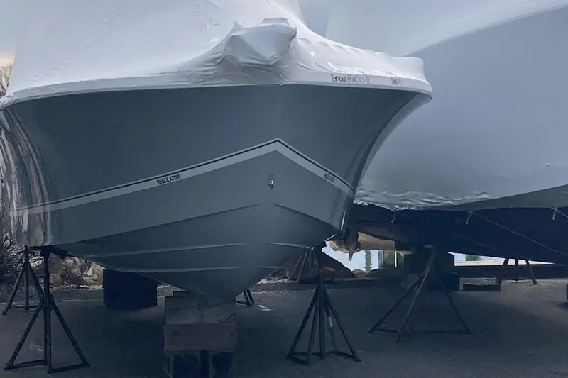 Slide: The Image of 2024 Regulator 30XO boat in storage, covered and elevated on stands. - 2