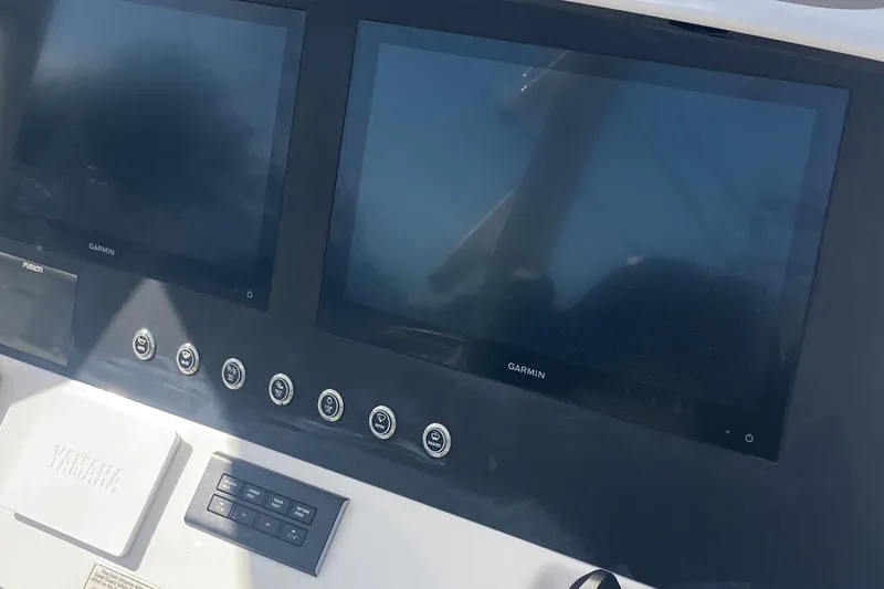 Slide: The Image of 2024 Regulator 30XO boat dashboard with Garmin displays and Yamaha controls. - 24