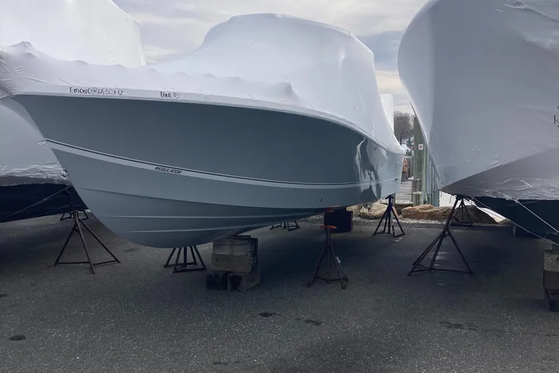 Slide: The Image of 2024 Regulator 30XO boat covered in protective wrap, elevated on stands. - 3
