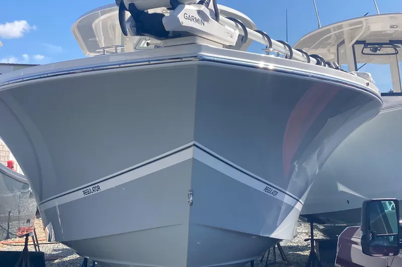 Slide: The Image of 2024 Regulator 30XO boat with Garmin equipment, docked under clear blue sky. - 5