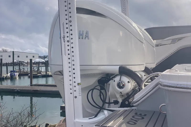 Slide: The Image of 2024 Regulator 30XO boat with Yamaha outboard motor at a marina. - 8