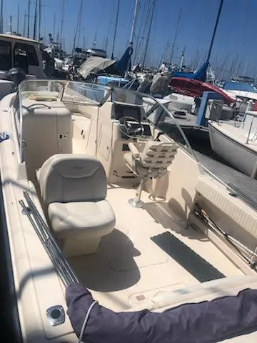 Slide: The Image of 2005 Grady-White Tournament 225 boat docked at marina, featuring spacious seating and helm. - 14