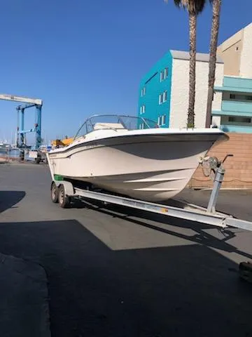 Slide: The Image of 2005 Grady-White Tournament 225 boat on trailer, urban background, clear sky. - 15