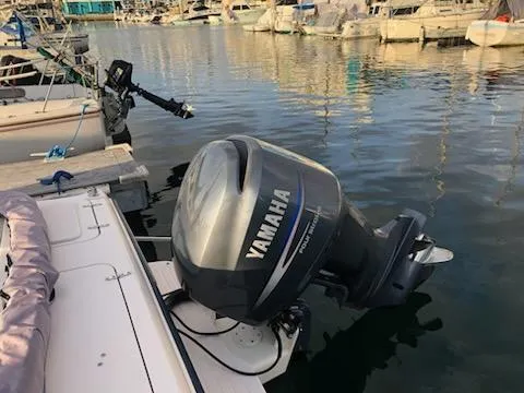 Slide: The Image of 2005 Grady-White Tournament 225 with Yamaha outboard motor docked at marina. - 9