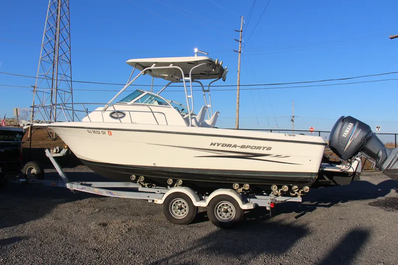 Slide: The Image of 2004 Hydra-Sports Lightning 230 WA boat on trailer, side view, clear sky background. - 1