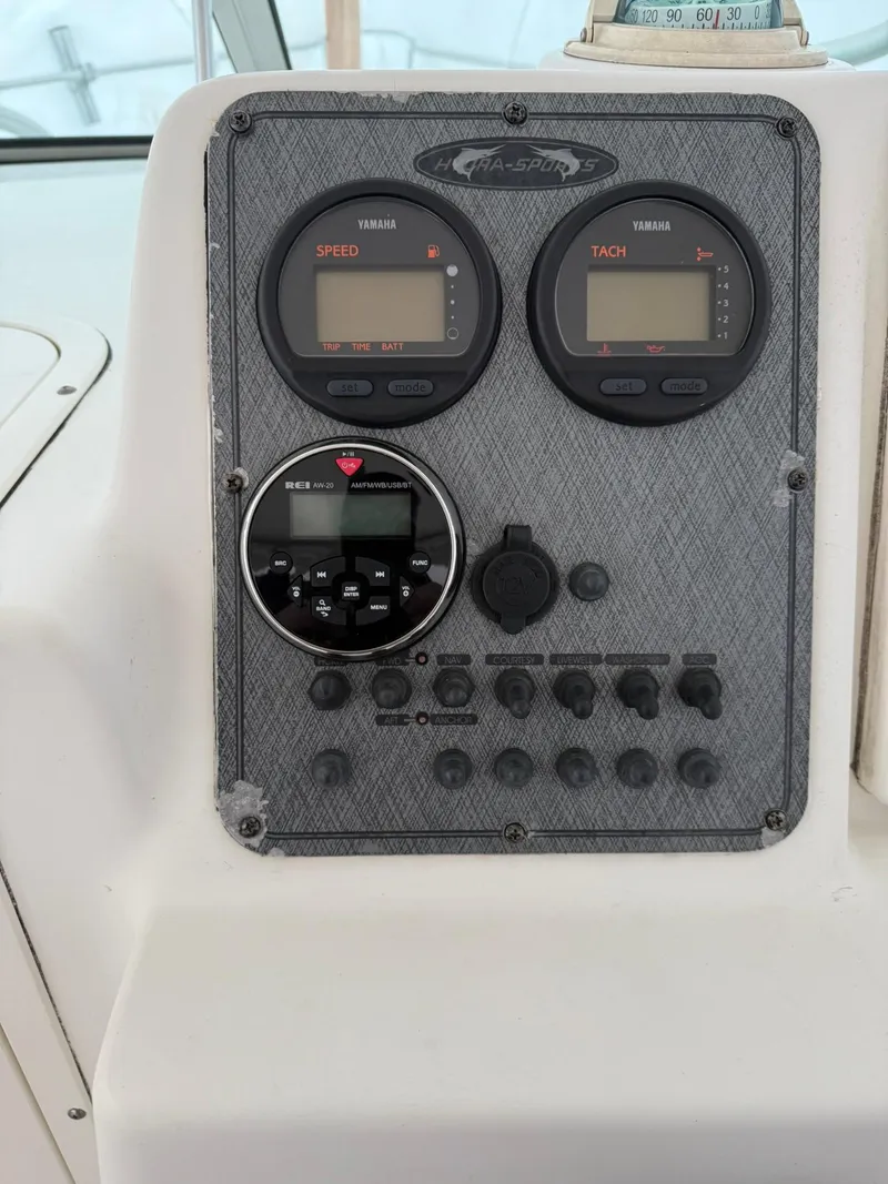 Slide: The Image of Dashboard of a 2004 Hydra-Sports Lightning 230 WA boat with gauges and controls. - 11