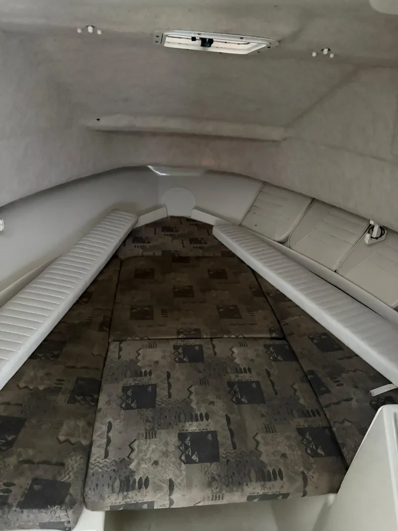 Slide: The Image of 2004 Hydra-Sports Lightning 230 WA cabin interior with cushioned seating and patterned upholstery. - 12