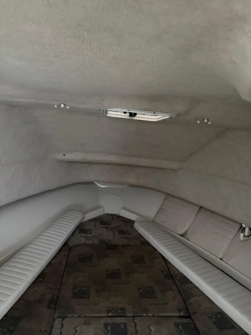 Slide: The Image of Interior cabin of 2004 Hydra-Sports Lightning 230 WA boat, featuring cushioned seating. - 13