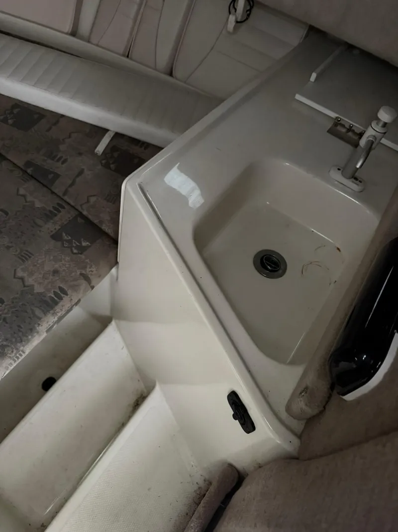 Slide: The Image of 2004 Hydra-Sports Lightning 230 WA interior with sink and seating area. - 14