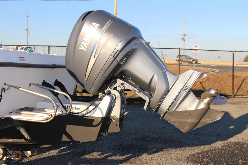 Slide: The Image of 2004 Hydra-Sports Lightning 230 WA with Yamaha outboard motor, parked on asphalt. - 2