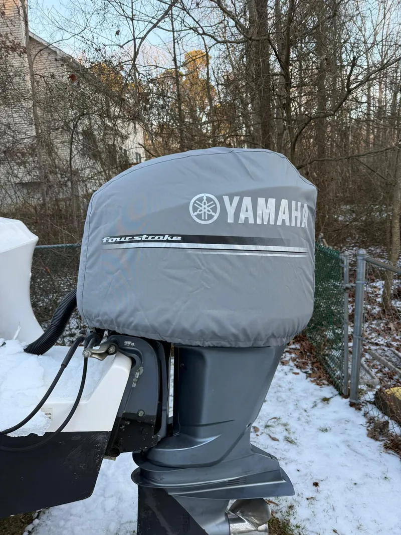 Slide: The Image of Yamaha outboard motor on 2004 Hydra-Sports Lightning 230 WA, covered in snow. - 21
