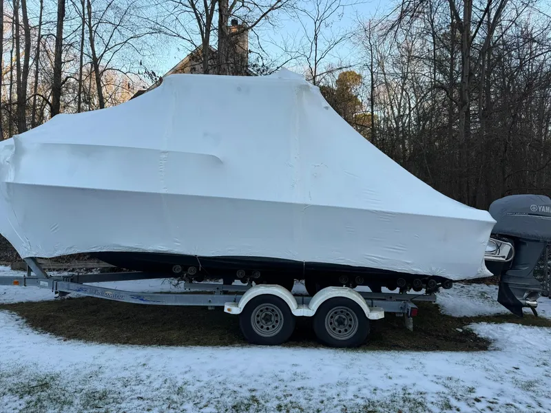 Slide: The Image of 2004 Hydra-Sports Lightning 230 WA boat covered in white tarp on trailer, winter setting. - 22