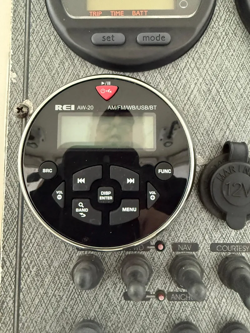 Slide: The Image of Close-up of a 2004 Hydra-Sports Lightning 230 WA boat dashboard with REI AW-20 radio controls. - 4