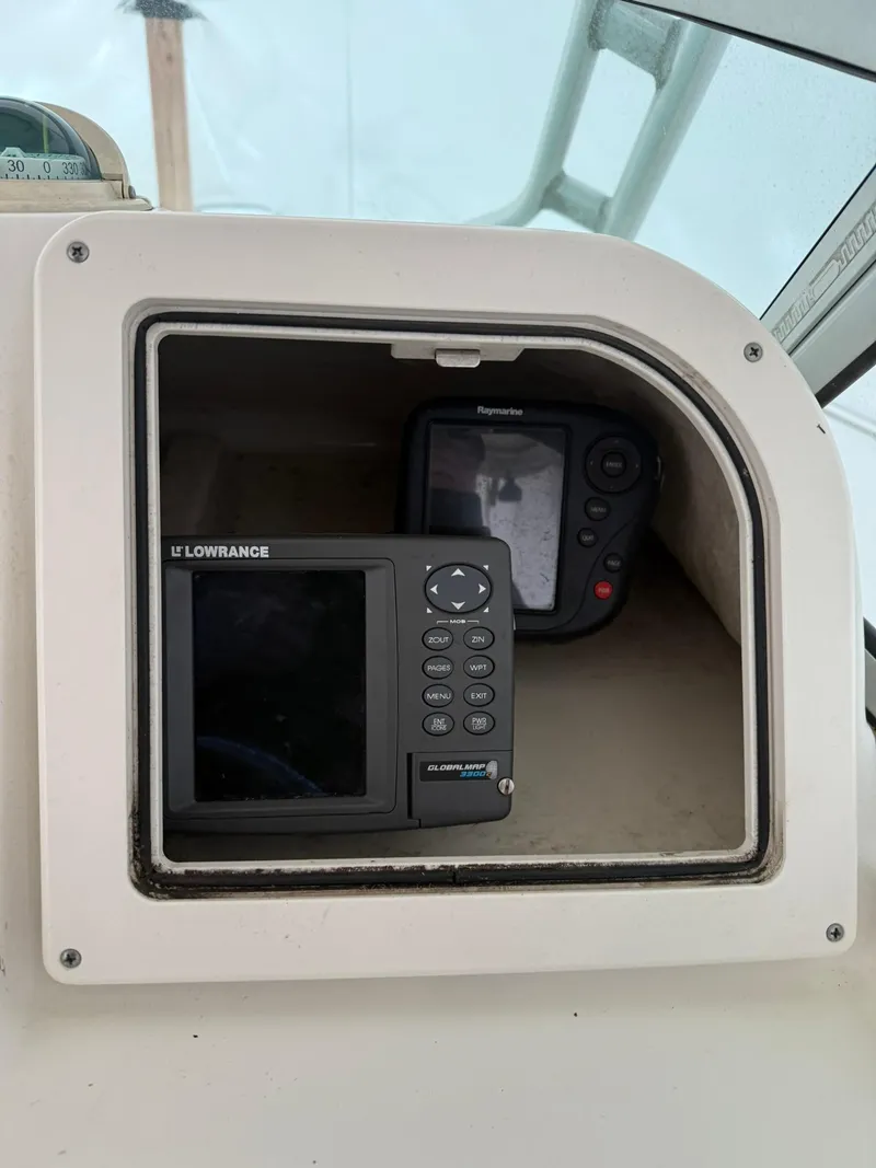 Slide: The Image of 2004 Hydra-Sports Lightning 230 WA boat dashboard with Lowrance navigation equipment. - 5