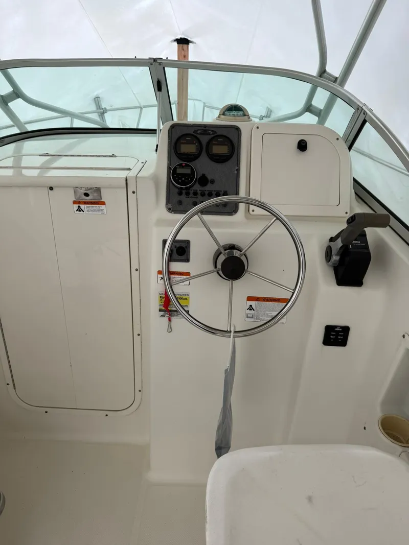 Slide: The Image of 2004 Hydra-Sports Lightning 230 WA boat cockpit with steering wheel and instrument panel. - 6