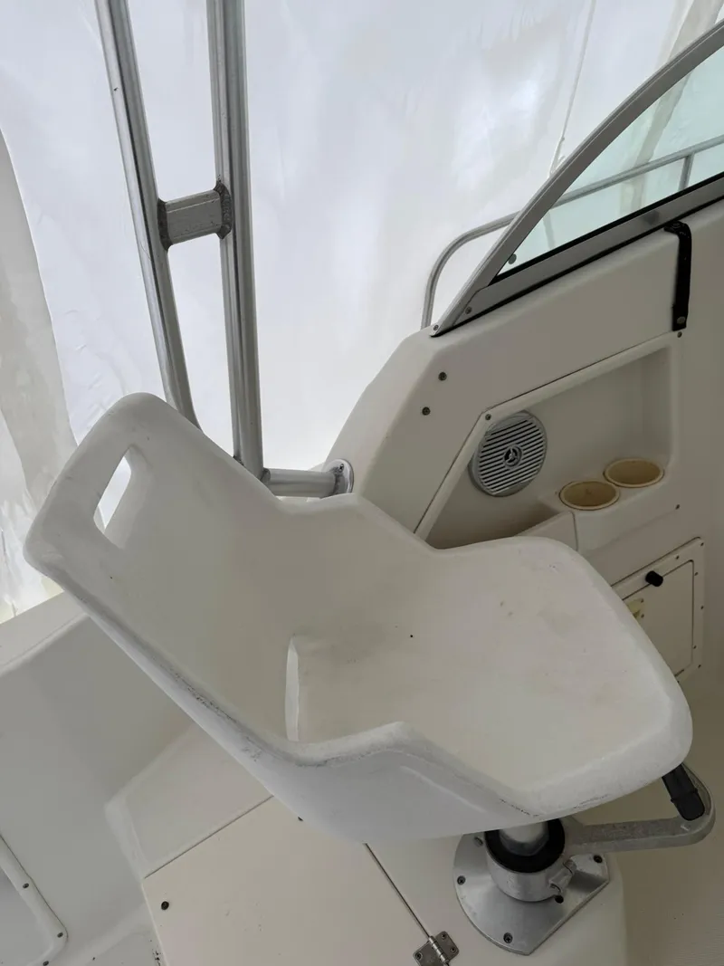 Slide: The Image of 2004 Hydra-Sports Lightning 230 WA boat interior with white seat and cup holders. - 7