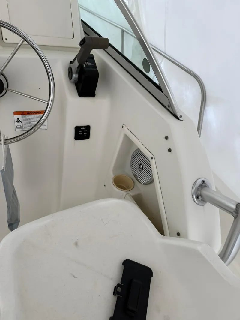 Slide: The Image of 2004 Hydra-Sports Lightning 230 WA boat interior with steering wheel and controls. - 8