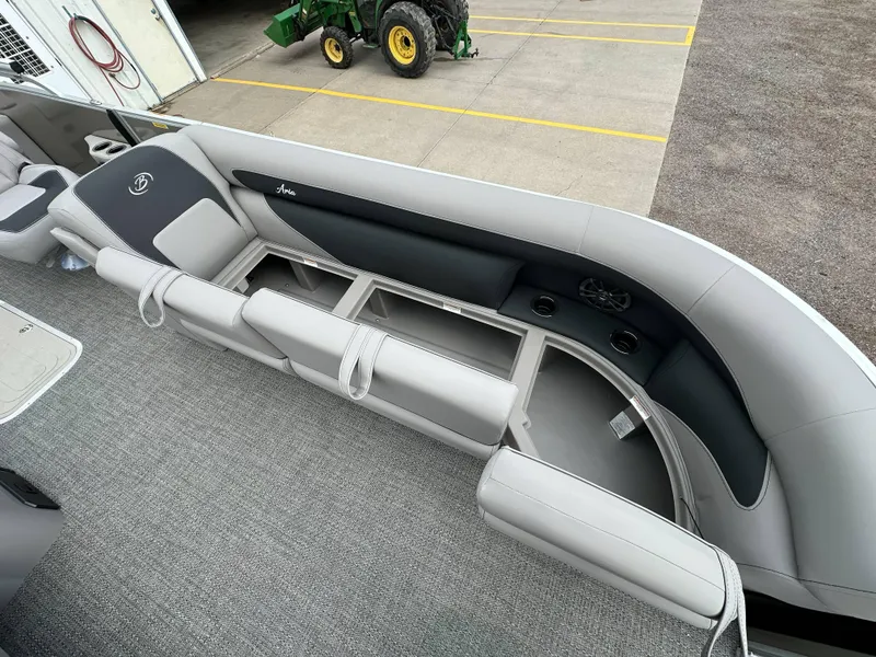 Slide: The Image of 2025 Barletta Aria 24UC pontoon boat interior with gray seating and storage compartments. - 10