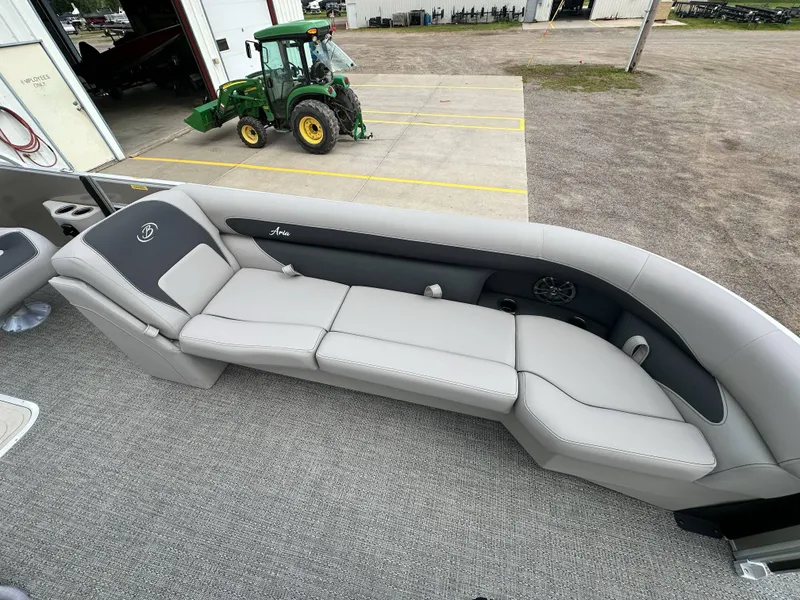 Slide: The Image of 2025 Barletta Aria 24UC pontoon boat interior with gray seating and carpet flooring. - 11