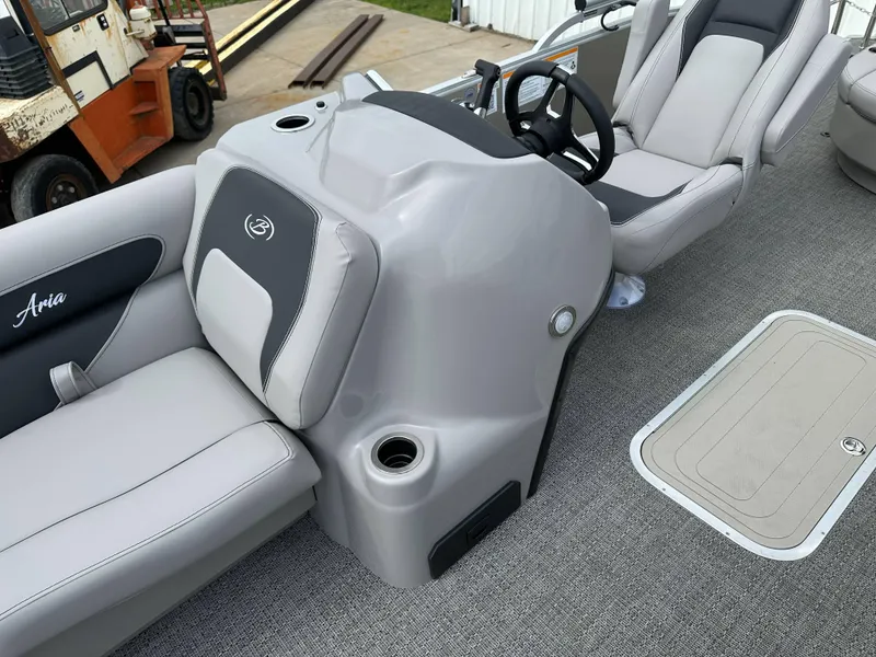 Slide: The Image of 2025 Barletta Aria 24UC boat interior with gray seating and steering console. - 12