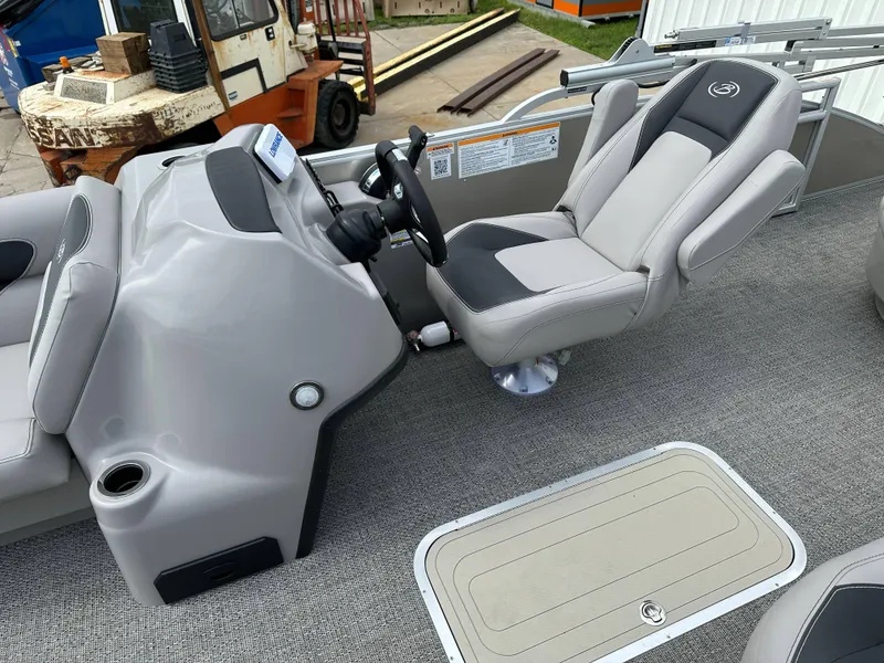 Slide: The Image of 2025 Barletta Aria 24UC boat interior with steering console and captain's chair. - 16