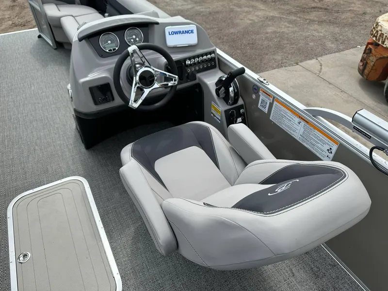 Slide: The Image of 2025 Barletta Aria 24UC boat interior with steering wheel and captain's chair. - 18