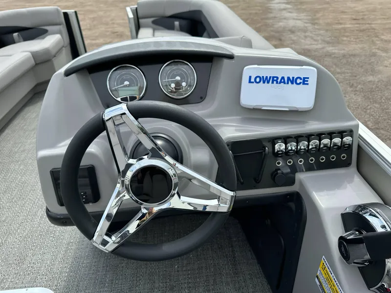 Slide: The Image of 2025 Barletta Aria 24UC boat dashboard with steering wheel and Lowrance display. - 19