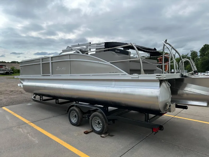 Slide: The Image of 2025 Barletta Aria 24UC pontoon boat on trailer under cloudy sky. - 27