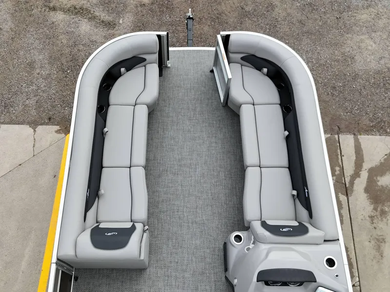 Slide: The Image of 2025 Barletta Aria 24UC pontoon boat interior with gray seating and carpet flooring. - 8