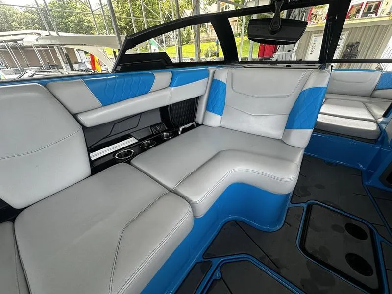 Slide: The Image of Interior of 2021 Malibu M220 boat with blue and white seating. - 14