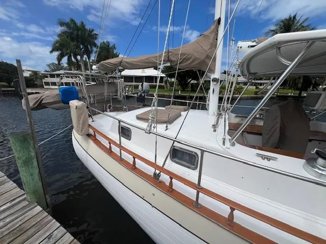 Slide: The Image of 1981 Hardin Voyager 45 Ketch docked, featuring classic design and wooden accents. - 13
