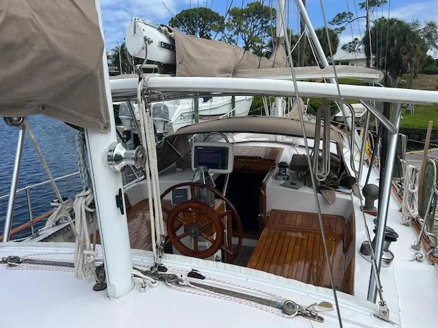 Slide: The Image of 1981 Hardin Voyager 45 Ketch sailboat cockpit with wooden accents and navigation equipment. - 21