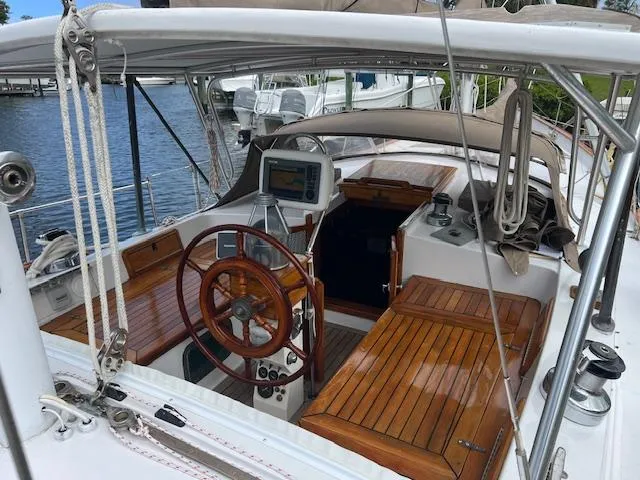 Slide: The Image of 1981 Hardin Voyager 45 Ketch cockpit with wooden steering wheel and navigation equipment. - 22