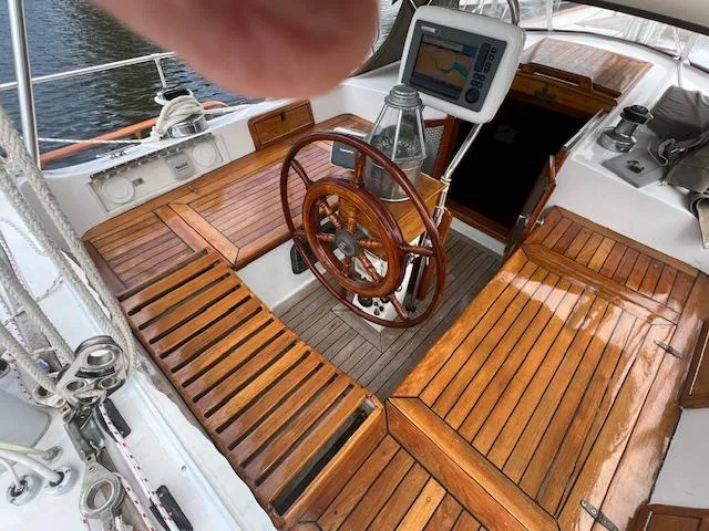 Slide: The Image of Cockpit of 1981 Hardin Voyager 45 Ketch with wooden seating and steering wheel. - 23