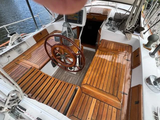 Slide: The Image of Cockpit of 1981 Hardin Voyager 45 Ketch with wooden seating and steering wheel. - 24