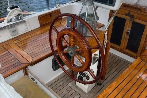 Slide: The Image of Wooden helm of 1981 Hardin Voyager 45 Ketch, featuring classic nautical design and craftsmanship. - 25