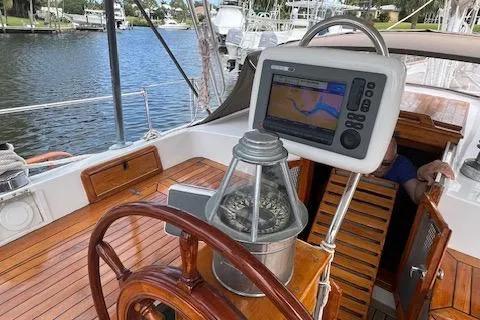 Slide: The Image of Hardin Voyager 45 Ketch 1981 cockpit with navigation equipment and wooden steering wheel. - 26