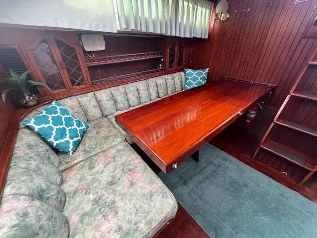Slide: The Image of Interior of 1981 Hardin Voyager 45 Ketch with wooden table, cushioned seating, and nautical decor. - 41