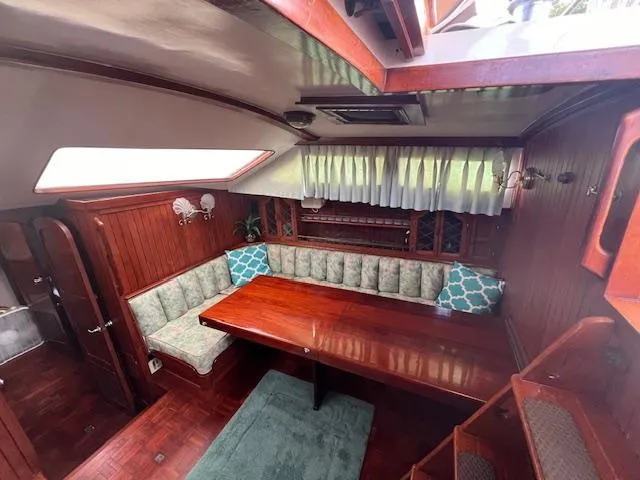 Slide: The Image of Interior of 1981 Hardin Voyager 45 Ketch with wood paneling and cushioned seating. - 42