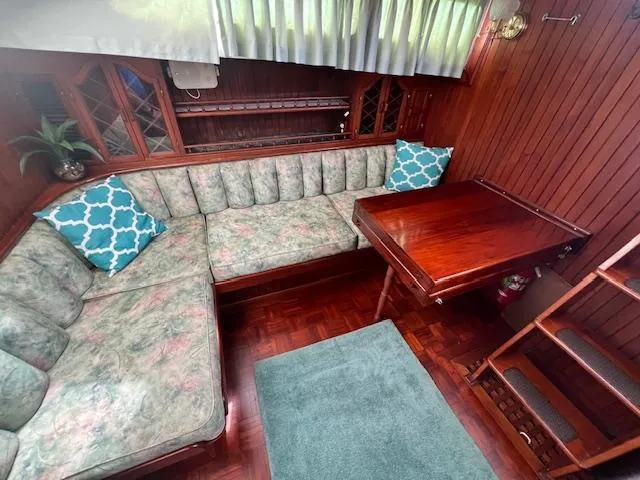 Slide: The Image of Interior of 1981 Hardin Voyager 45 Ketch with cozy seating and wooden table. - 43