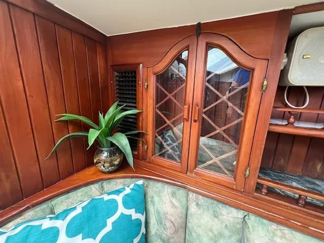 Slide: The Image of Interior of 1981 Hardin Voyager 45 Ketch with wooden cabinets and decorative plant. - 45