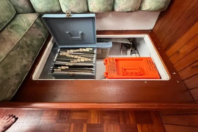 Slide: The Image of Hidden storage compartment on 1981 Hardin Voyager 45 Ketch with organized files and safety equipment. - 49