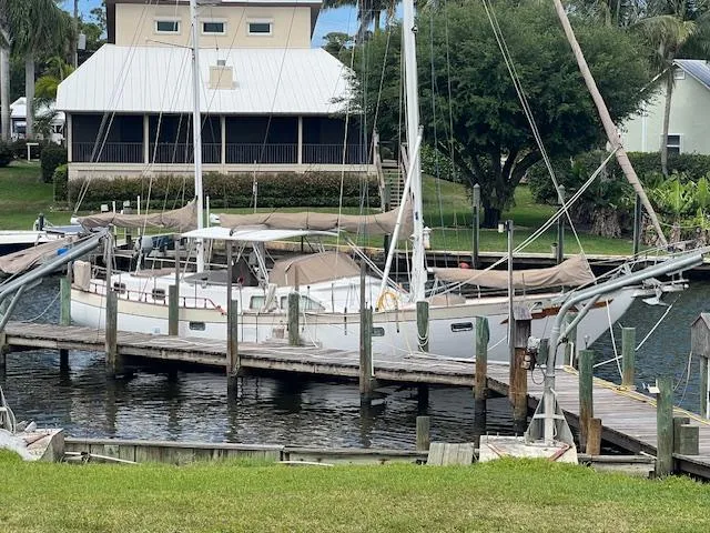 Slide: The Image of 1981 Hardin Voyager 45 Ketch docked by a waterfront home. - 9