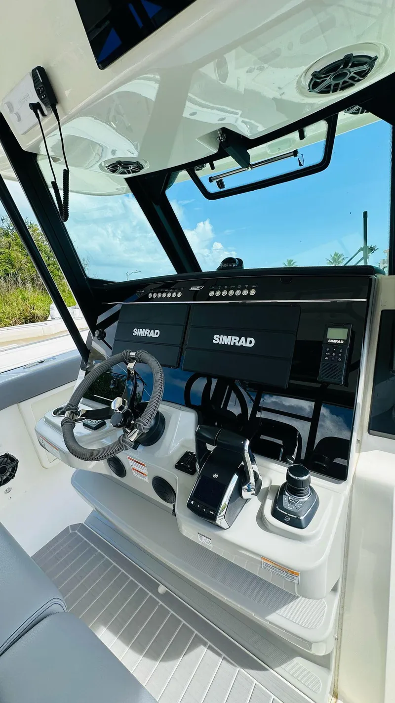 Slide: The Image of 2023 Boston Whaler 360 Outrage helm with Simrad electronics and modern controls. - 11