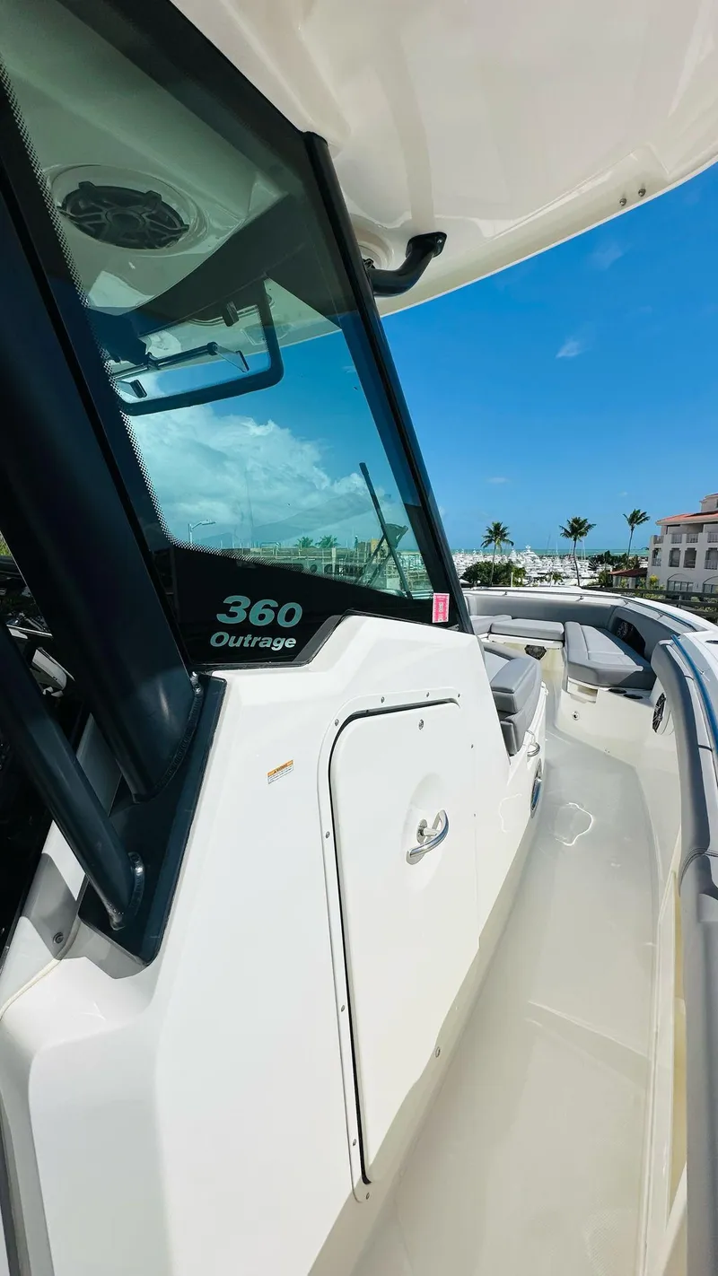 Slide: The Image of 2023 Boston Whaler 360 Outrage boat, sleek design, sunny day, clear blue sky. - 12