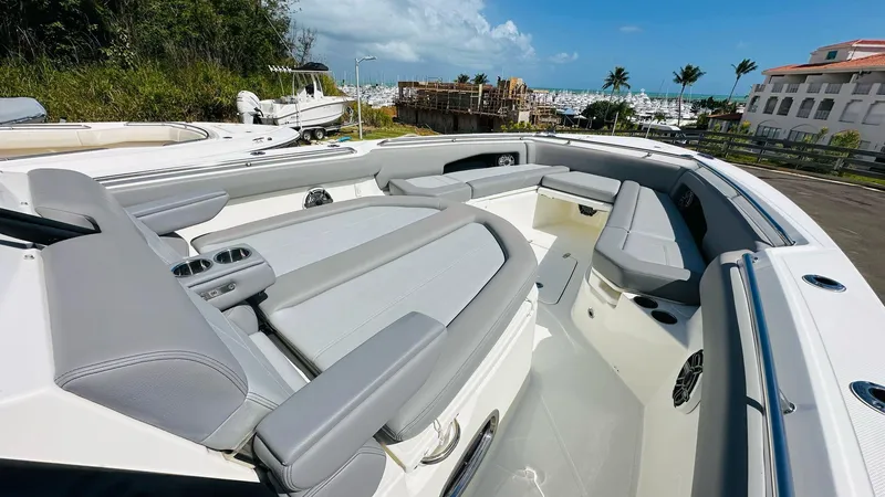 Slide: The Image of 2023 Boston Whaler 360 Outrage boat interior with luxurious seating and ocean view. - 4
